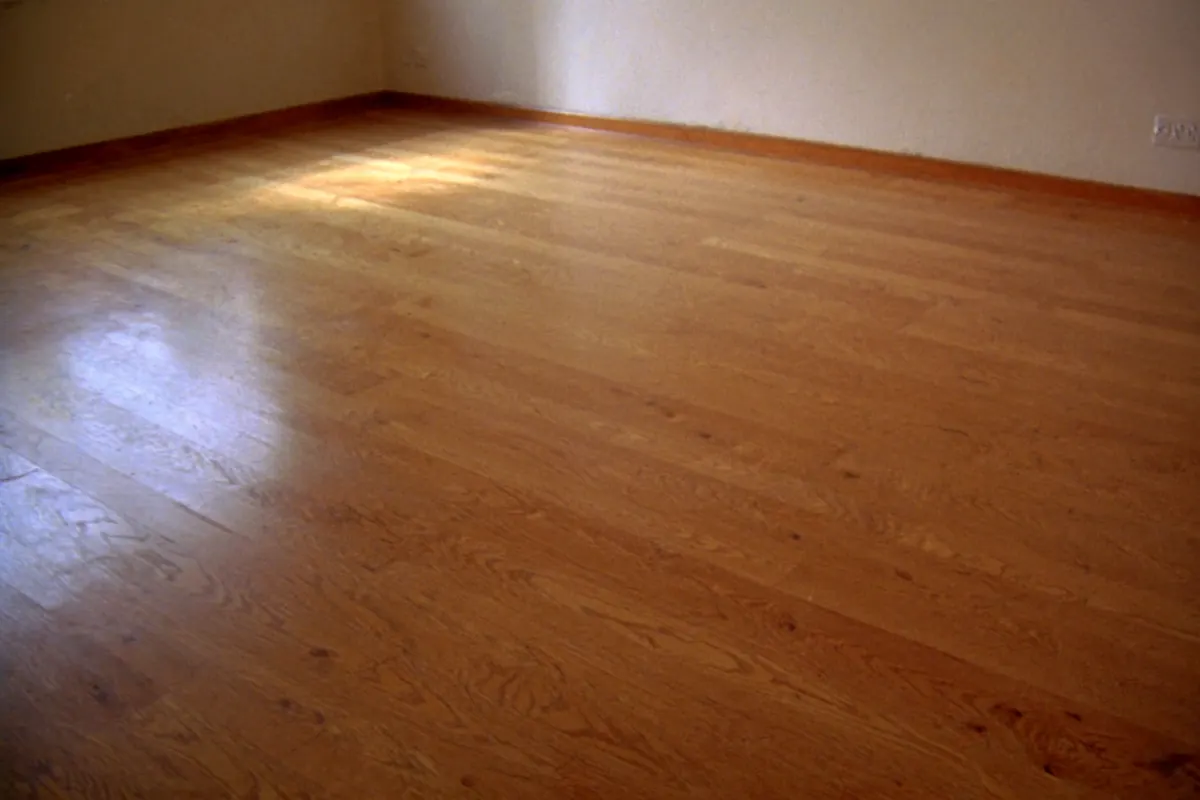 A freshly refinished oak floor with an even satin sheen catching the daylight